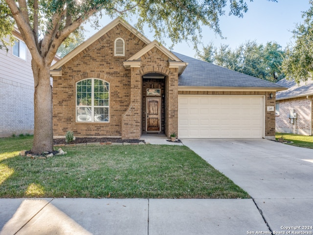 view of front of property featuring a front yard and a garage