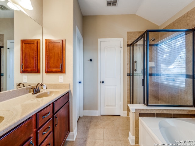 bathroom with tile patterned flooring, vanity, lofted ceiling, and independent shower and bath