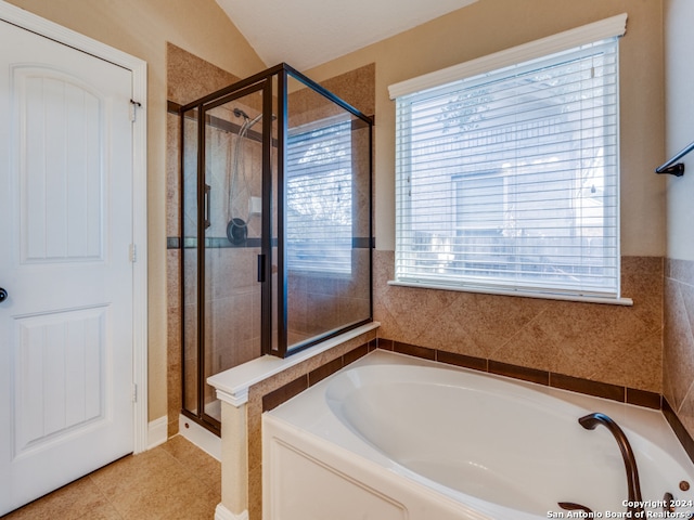 bathroom featuring separate shower and tub, tile patterned floors, and vaulted ceiling