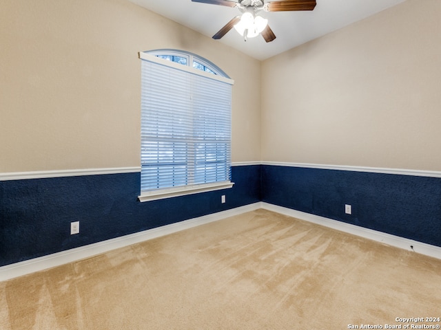 unfurnished room featuring ceiling fan and carpet floors