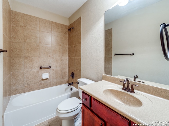 full bathroom featuring vanity, tiled shower / bath combo, and toilet