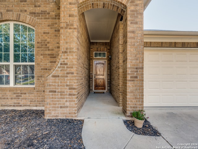 view of exterior entry with a garage