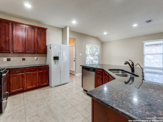 kitchen with white fridge with ice dispenser, stainless steel dishwasher, plenty of natural light, and sink