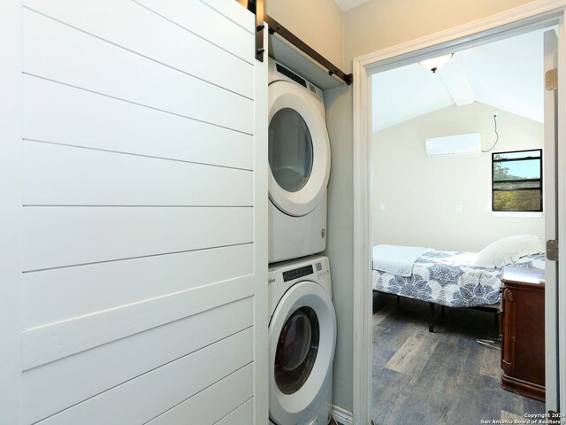 washroom featuring dark wood-type flooring and stacked washing maching and dryer