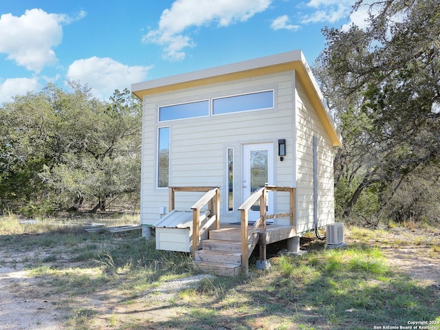 view of front of house featuring cooling unit