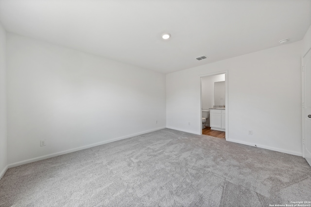 empty room featuring light carpet