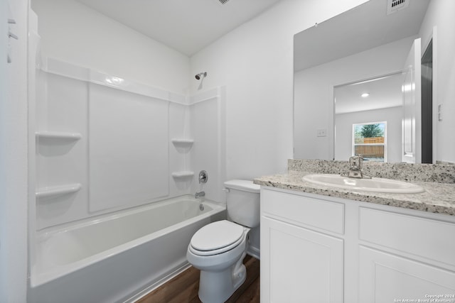 full bathroom with bathing tub / shower combination, hardwood / wood-style flooring, vanity, and toilet