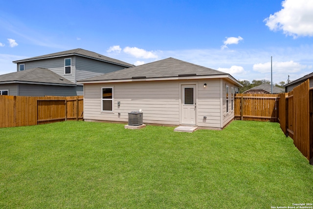 back of property featuring a yard and central AC unit