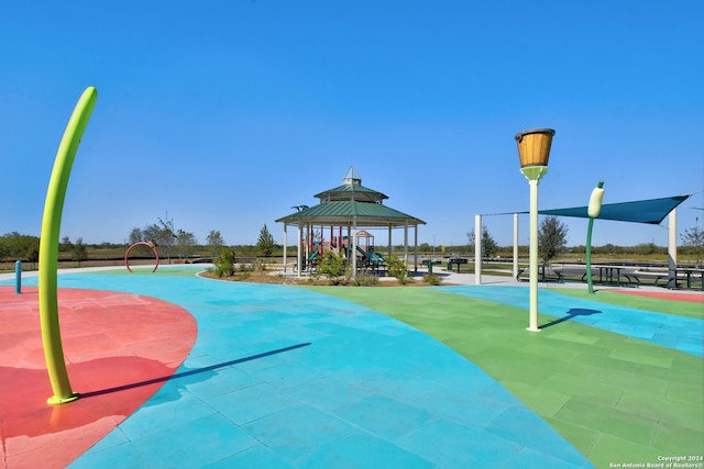 view of community with a gazebo and basketball hoop