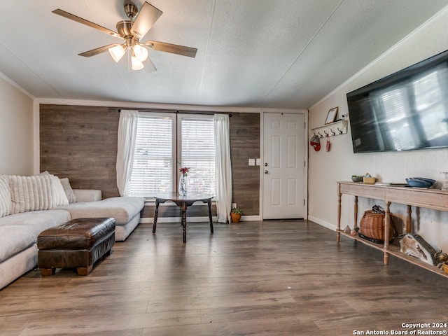 living room with a textured ceiling, ceiling fan, dark hardwood / wood-style floors, lofted ceiling, and wood walls