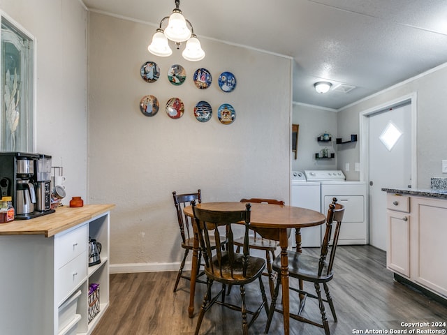 dining room with separate washer and dryer, crown molding, dark hardwood / wood-style flooring, and a textured ceiling