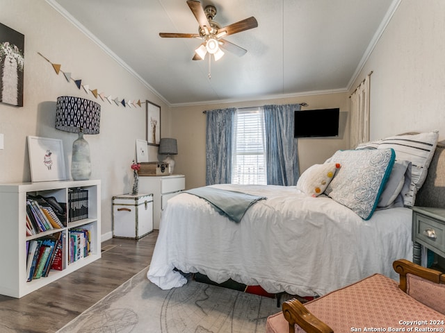 bedroom with ceiling fan, crown molding, and dark wood-type flooring