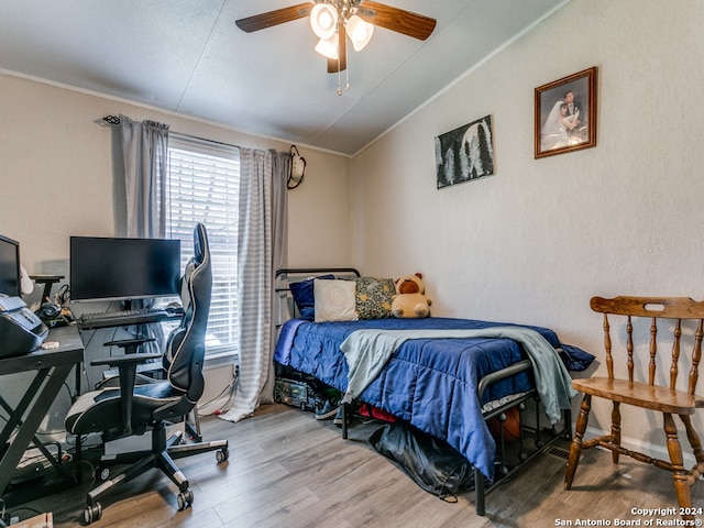 bedroom featuring ceiling fan, hardwood / wood-style floors, crown molding, and lofted ceiling