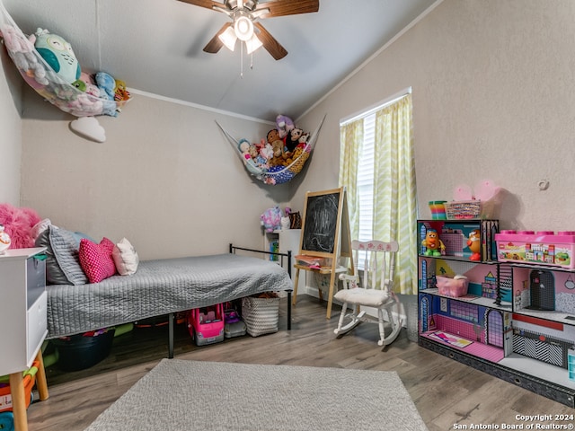 bedroom featuring ceiling fan, wood-type flooring, and ornamental molding