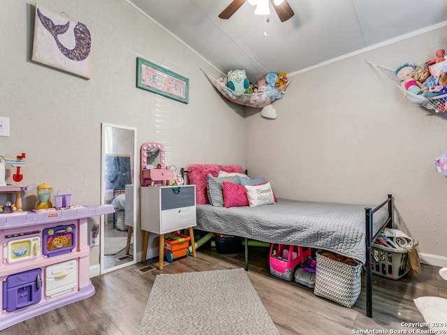 bedroom with hardwood / wood-style floors, ceiling fan, and crown molding