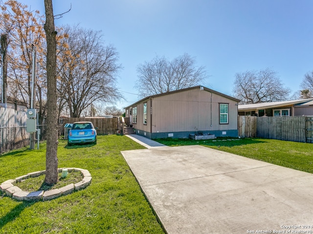 view of side of home featuring a lawn