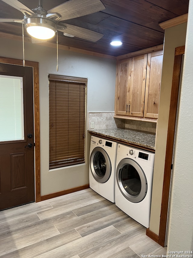 laundry room featuring wooden ceiling, washing machine and dryer, light wood-style flooring, baseboards, and cabinet space