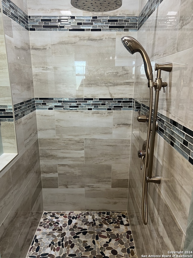 bathroom with tiled shower