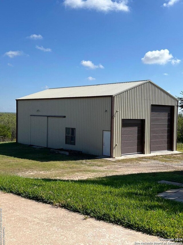 view of outbuilding with driveway and an outdoor structure