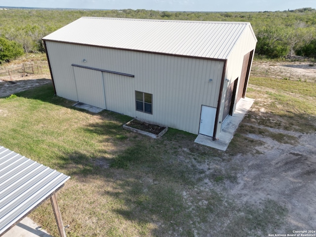 view of pole building featuring a yard and fence