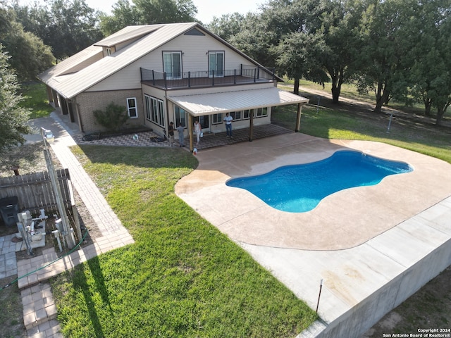 view of swimming pool featuring a fenced in pool, a patio, fence, and a lawn