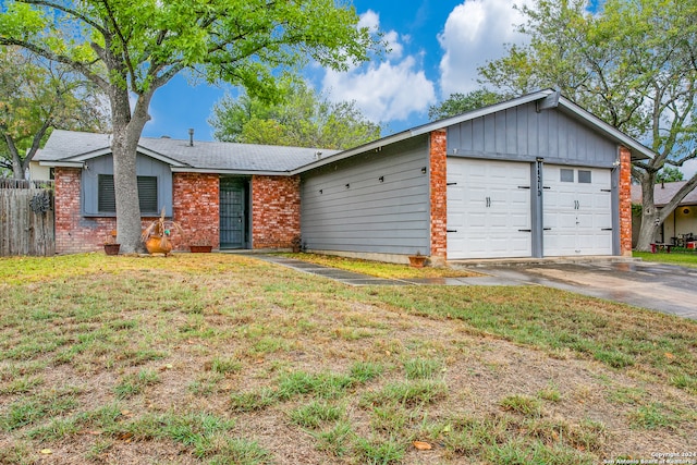 ranch-style house with a garage and a front lawn