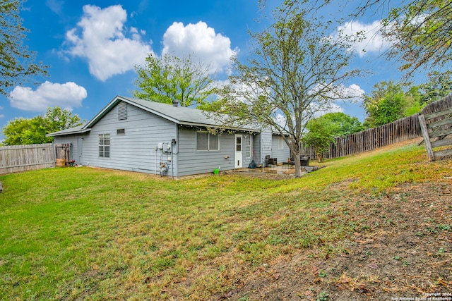 rear view of property with a lawn