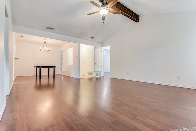 empty room featuring hardwood / wood-style flooring, vaulted ceiling with beams, and ceiling fan with notable chandelier