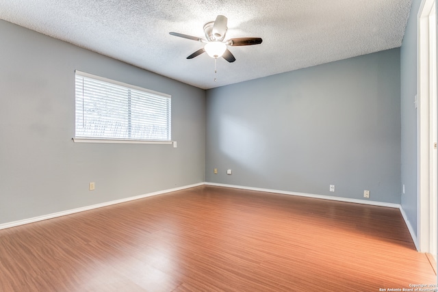 empty room featuring hardwood / wood-style floors, a textured ceiling, and ceiling fan