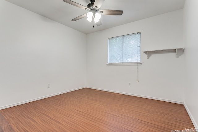 spare room featuring hardwood / wood-style floors and ceiling fan