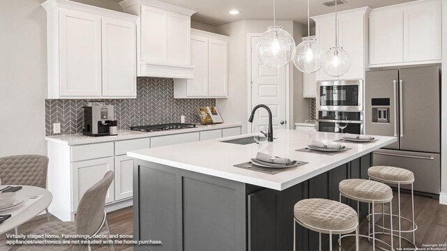 1863 Weinnacht, New Braunfels, TX 78132 - kitchen with a sink, appliances with stainless steel finishes, an island with sink, light countertops, and recessed lighting