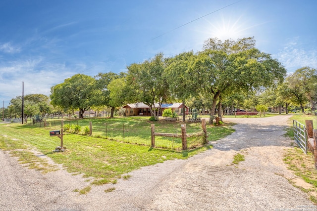 view of property's community featuring a yard and a rural view