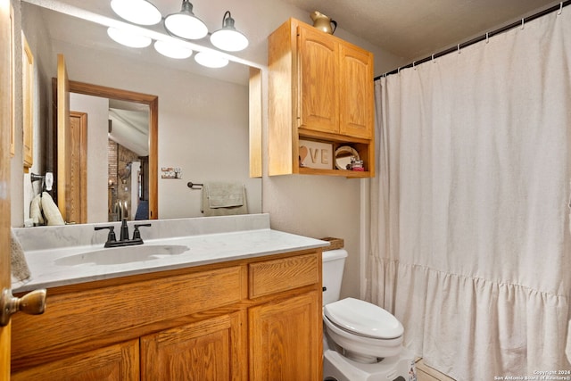 bathroom with vanity, toilet, and a chandelier