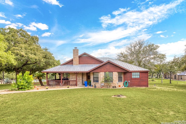 rear view of property featuring a yard