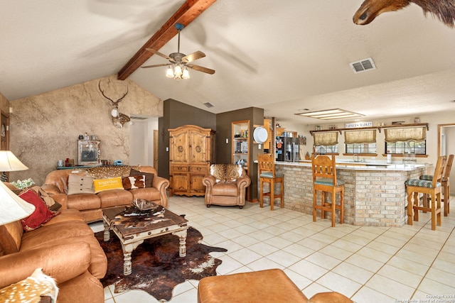 tiled living room featuring a textured ceiling, vaulted ceiling with beams, ceiling fan, and sink