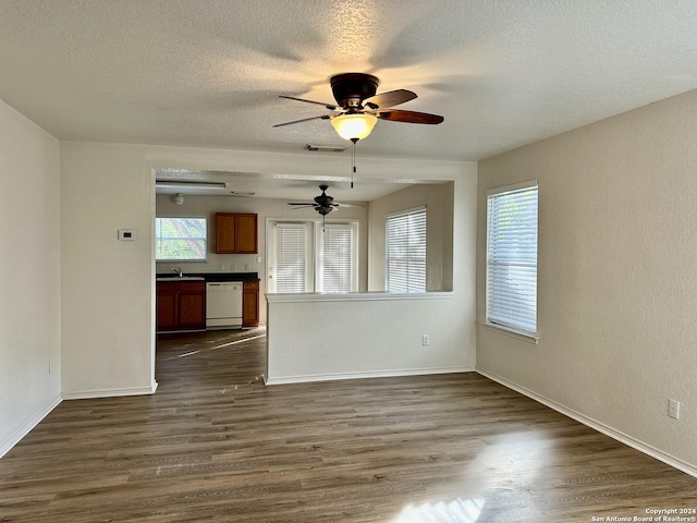 330 Agency Oaks, San Antonio, TX 78249 - unfurnished living room with a ceiling fan, dark wood-style flooring, a textured ceiling, baseboards, and a sink