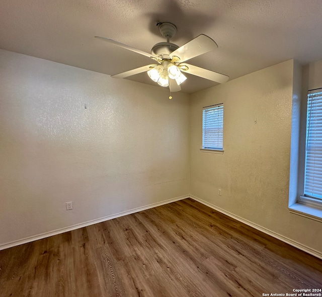 unfurnished room featuring hardwood / wood-style flooring, ceiling fan, and a textured ceiling