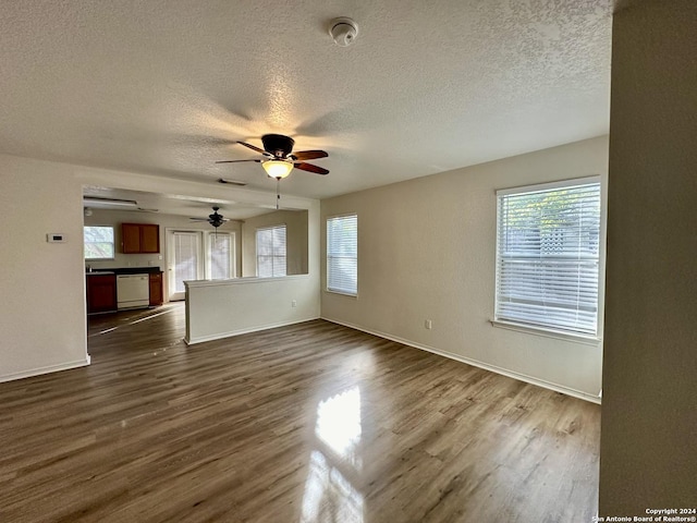 330 Agency Oaks, San Antonio, TX 78249 - unfurnished living room with ceiling fan, a textured ceiling, dark wood finished floors, and baseboards