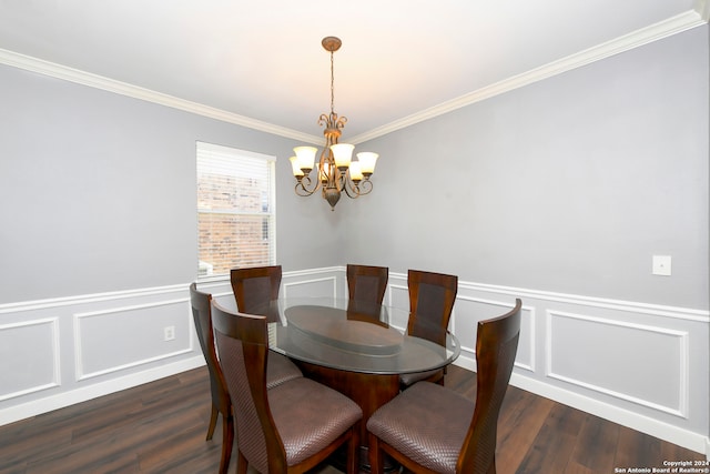 dining room with dark hardwood / wood-style floors, crown molding, and an inviting chandelier