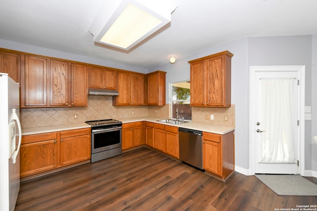 kitchen with dark hardwood / wood-style floors, sink, decorative backsplash, and stainless steel appliances