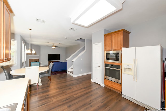 kitchen featuring ceiling fan, hanging light fixtures, stainless steel appliances, and dark hardwood / wood-style floors