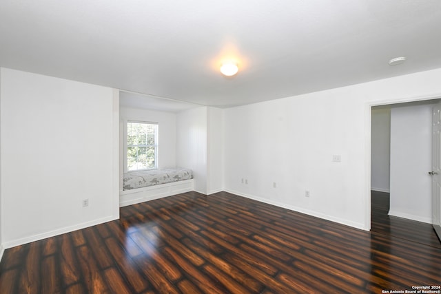 spare room featuring dark hardwood / wood-style floors