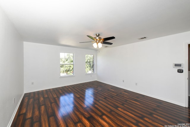 spare room with ceiling fan and dark wood-type flooring