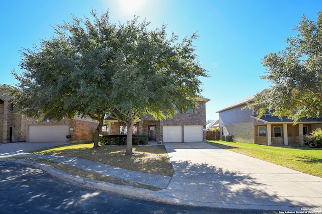 obstructed view of property featuring a garage and a front lawn