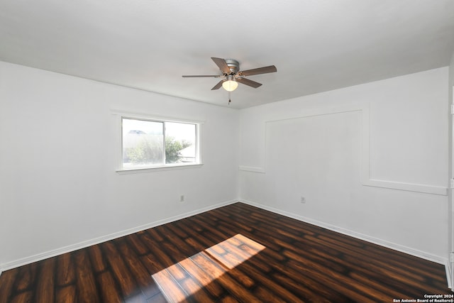 unfurnished room featuring dark hardwood / wood-style floors and ceiling fan