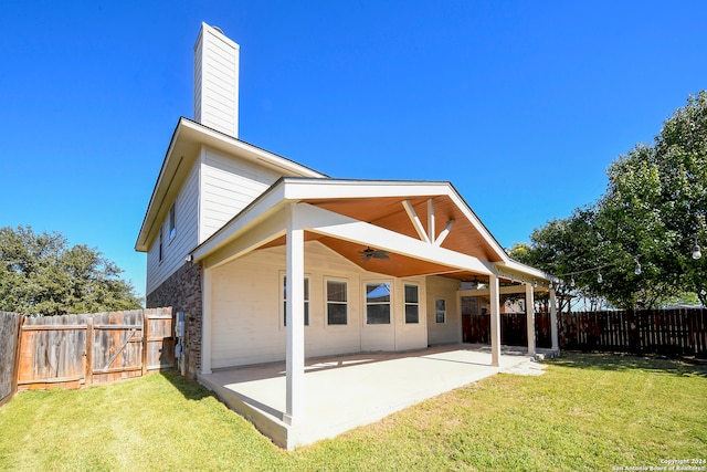 back of property featuring a patio area, ceiling fan, and a yard