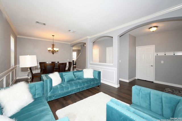 living room with ornamental molding, an inviting chandelier, and dark wood-type flooring