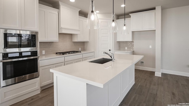 1927 Friedrich Way, New Braunfels, TX 78130 - kitchen featuring appliances with stainless steel finishes, a sink, recessed lighting, baseboards, and white cabinetry