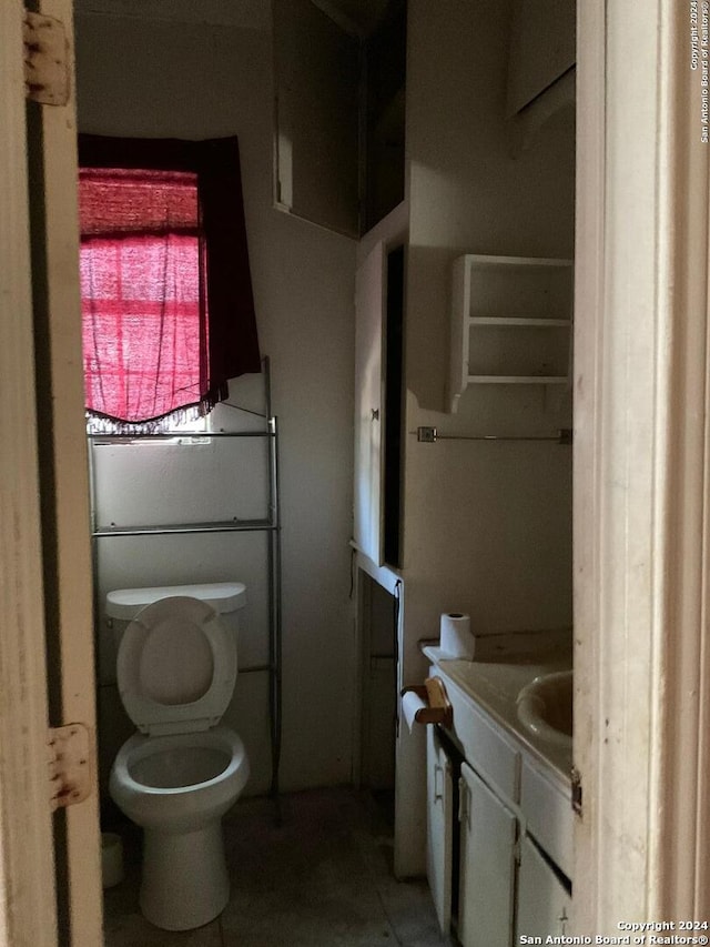 5222 Lark, San Antonio, TX 78228 - half bathroom with vanity, toilet, and tile patterned flooring
