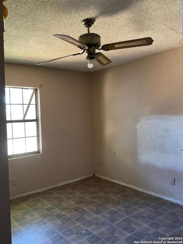 5222 Lark, San Antonio, TX 78228 - empty room featuring ceiling fan, a textured ceiling, and baseboards